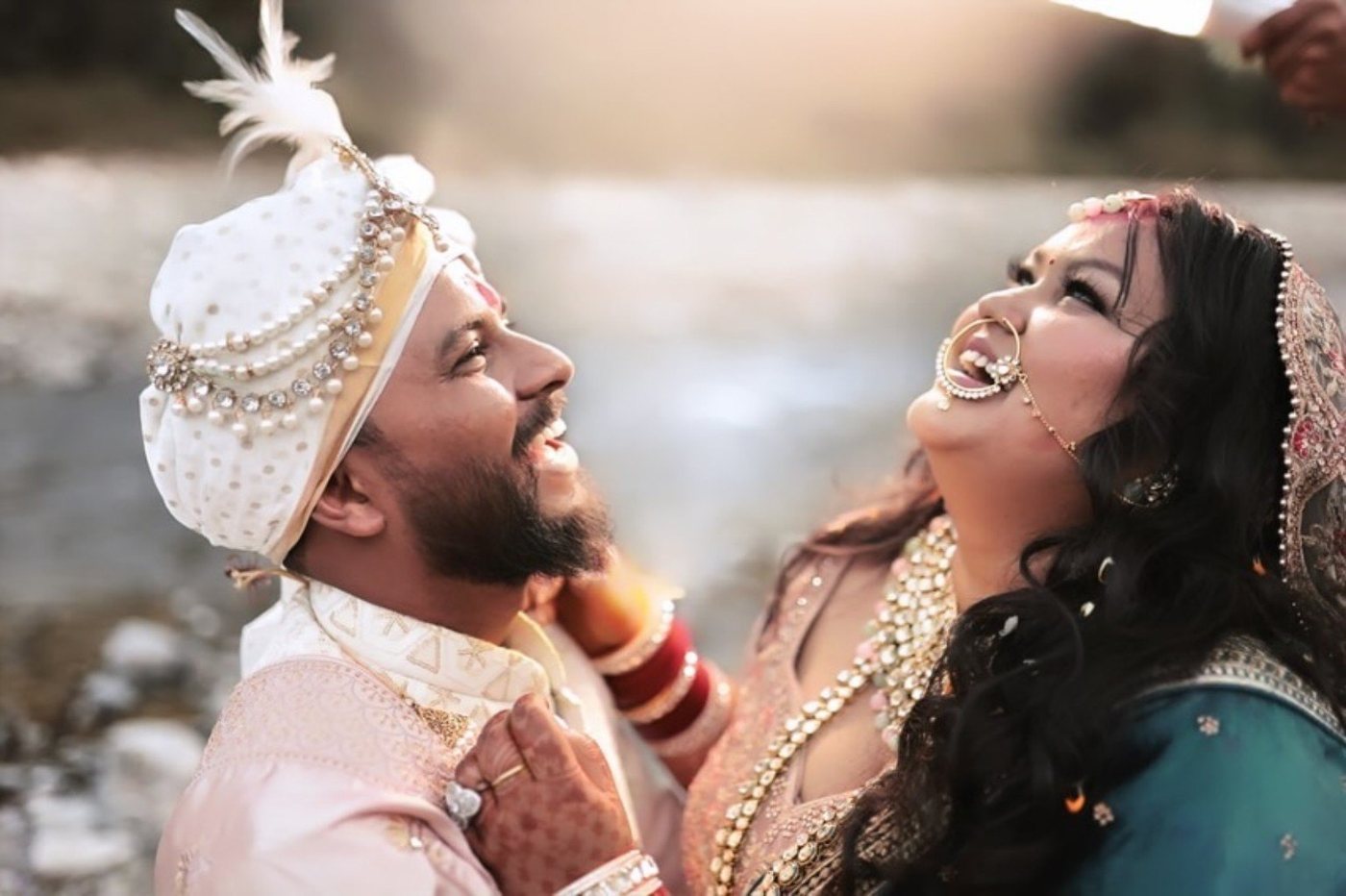 Joyful candid bride and groom laughing together