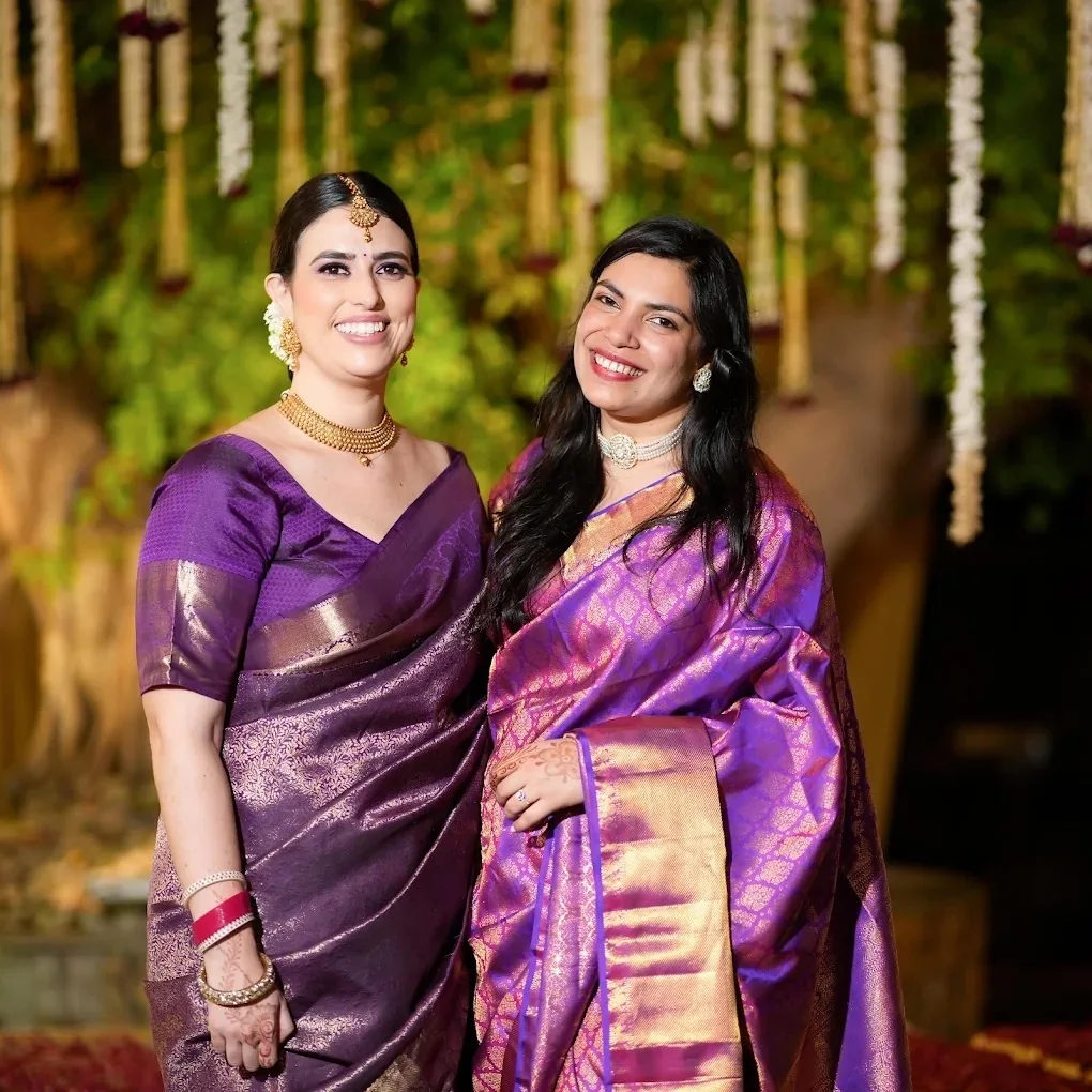 Family in purple Kanjeevaram silk sarees for heirloom wedding photobooks by Wedding Shedding